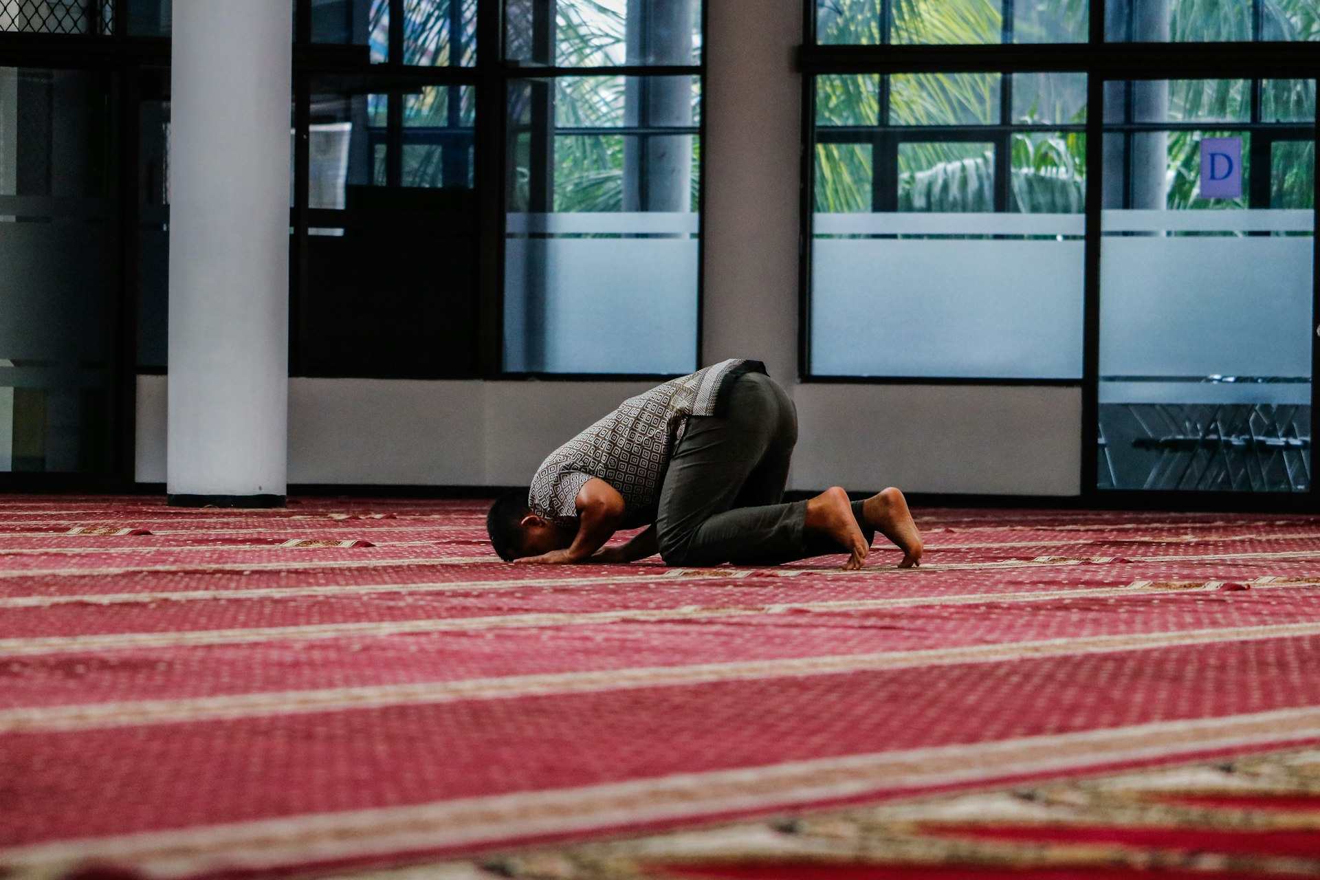 a person kneeling down on a rug in a room